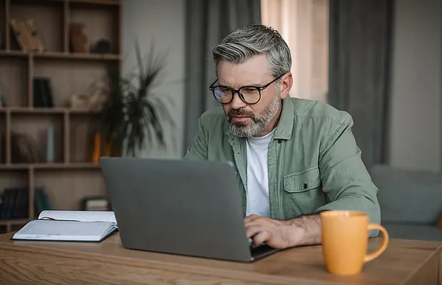 Man is looking into his notebook