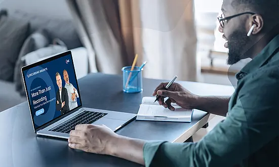 Person attending an ASC Recording Insights webinar and watching an session on the laptop