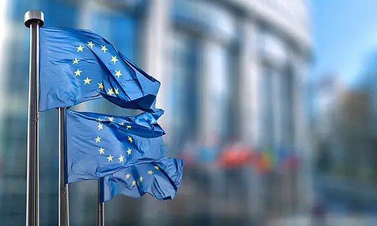 EU flags waving in front of a building – Symbolizing data protection and GDPR