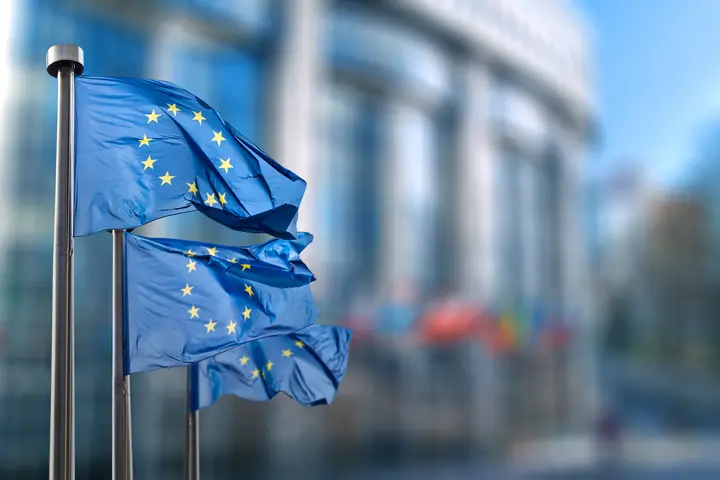 European Union and Data Protection – GDPR in Focus EU flags waving in front of a building – Symbolizing data protection and GDPR