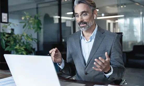 Businessman in a modern office conducting an online consultation with a client about financial services