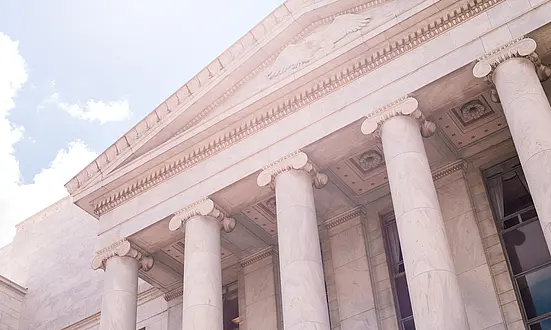 Regierungsgebäude mit Säulenfront bei hellem Himmel