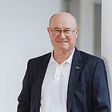 Ein Portraitfoto von Günter Müller, Executive Chairman bei ASC Technologies vor neutralem Hintergrund